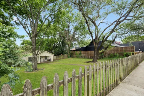 a view of house with wooden fence