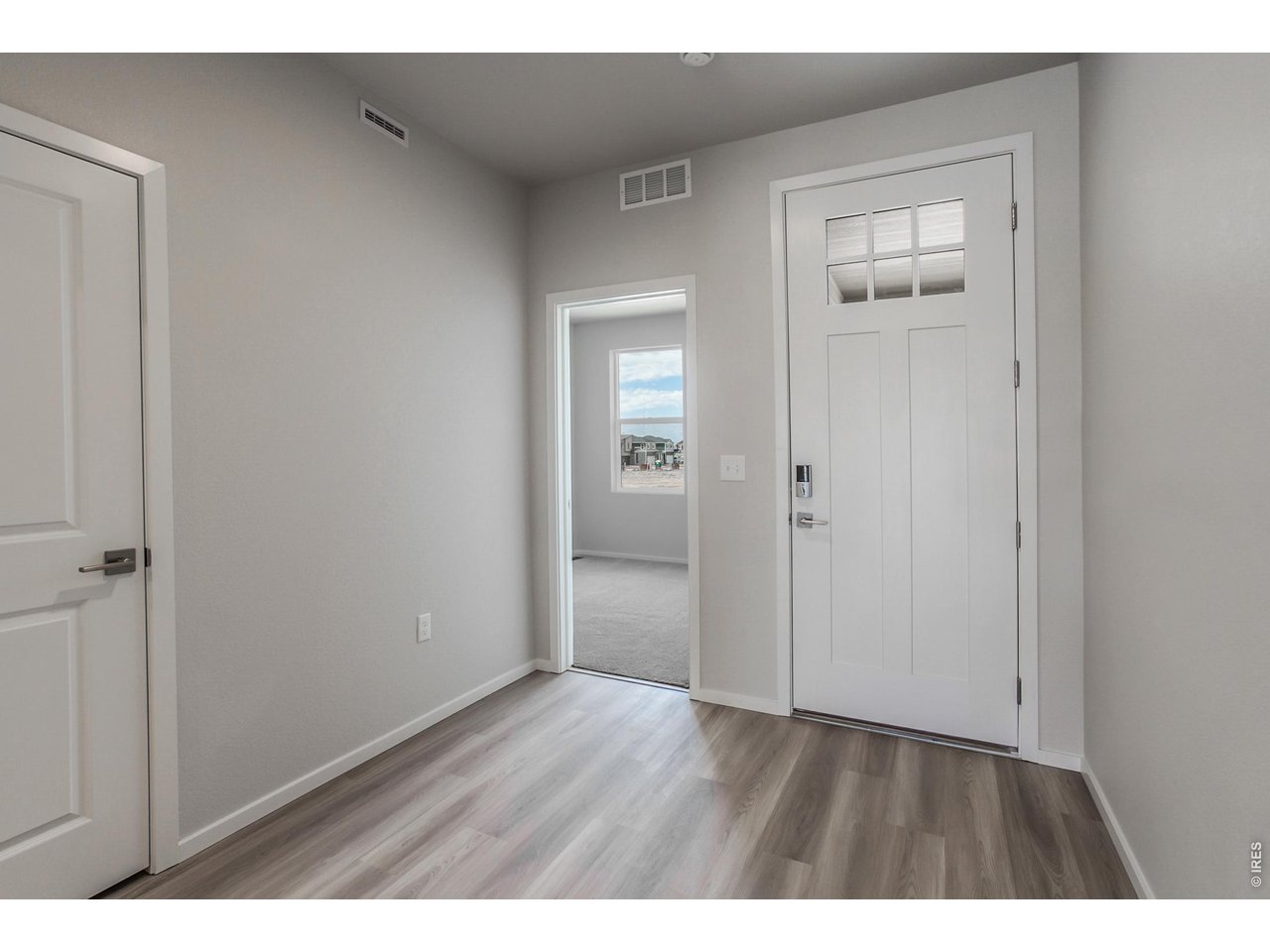 792 Chatter Road Windsor, CO 80550 - Photo 4 of 49 a view of an empty room with wooden floor