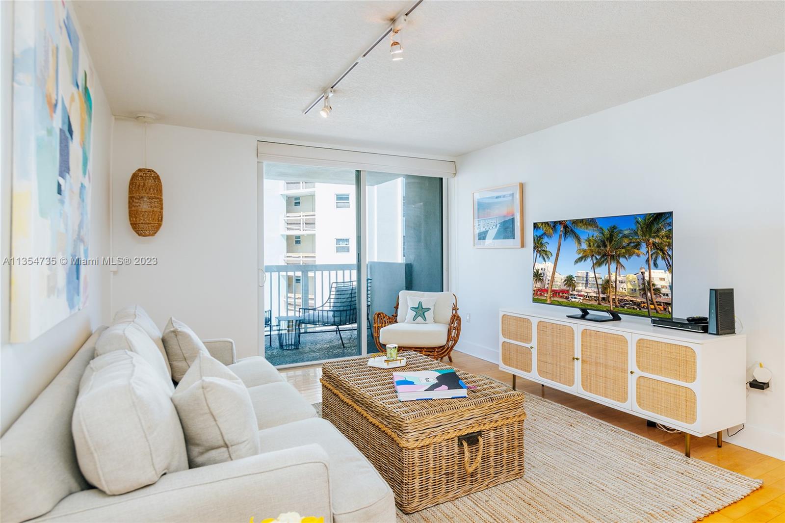 1670 Bay Road, Unit 4F Miami Beach, FL 33139 - Photo 2 of 12 a living room with furniture and a flat screen tv