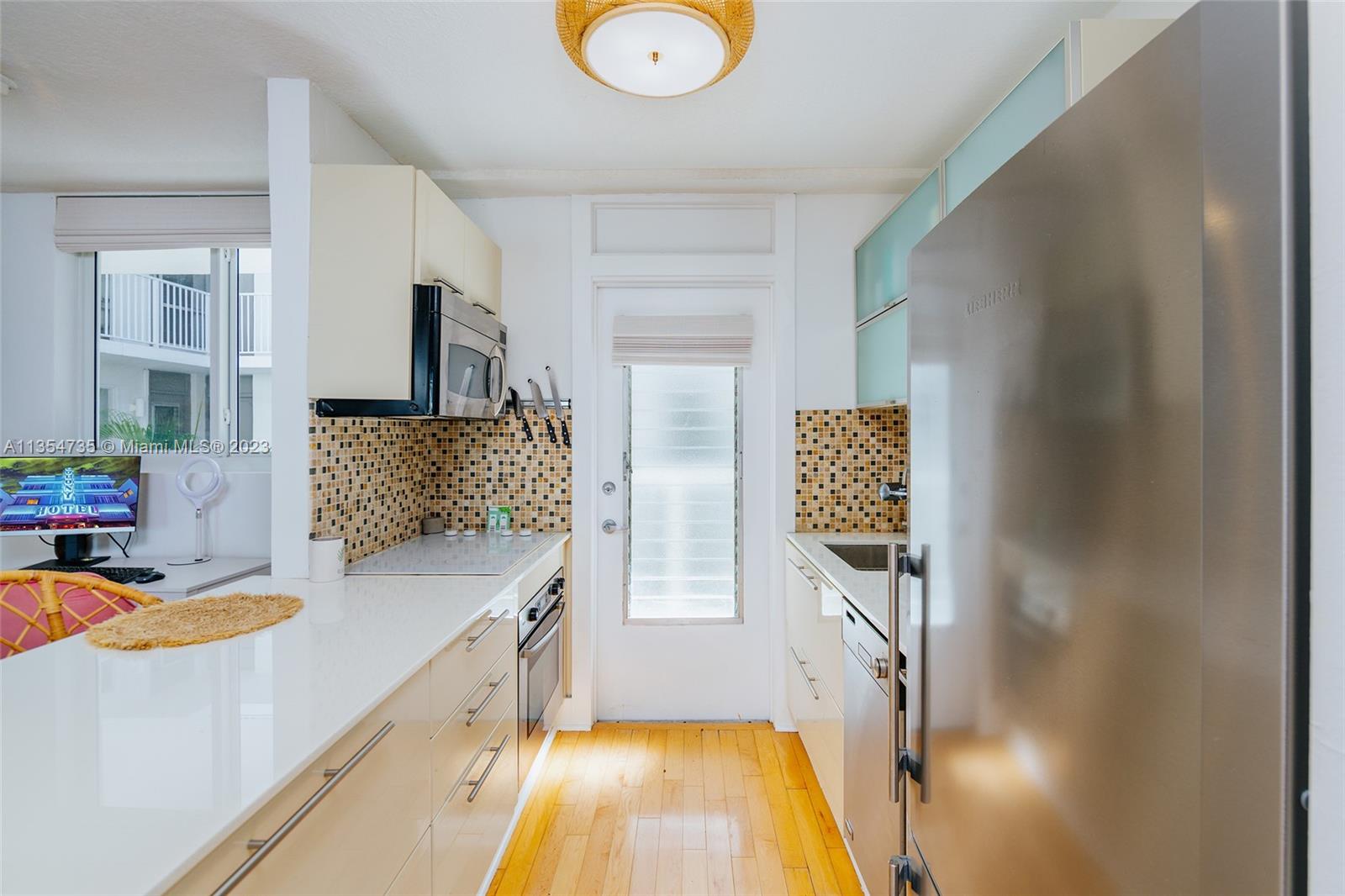 1670 Bay Road, Unit 4F Miami Beach, FL 33139 - Photo 3 of 12 a spacious bathroom with a granite countertop tub sink and mirror