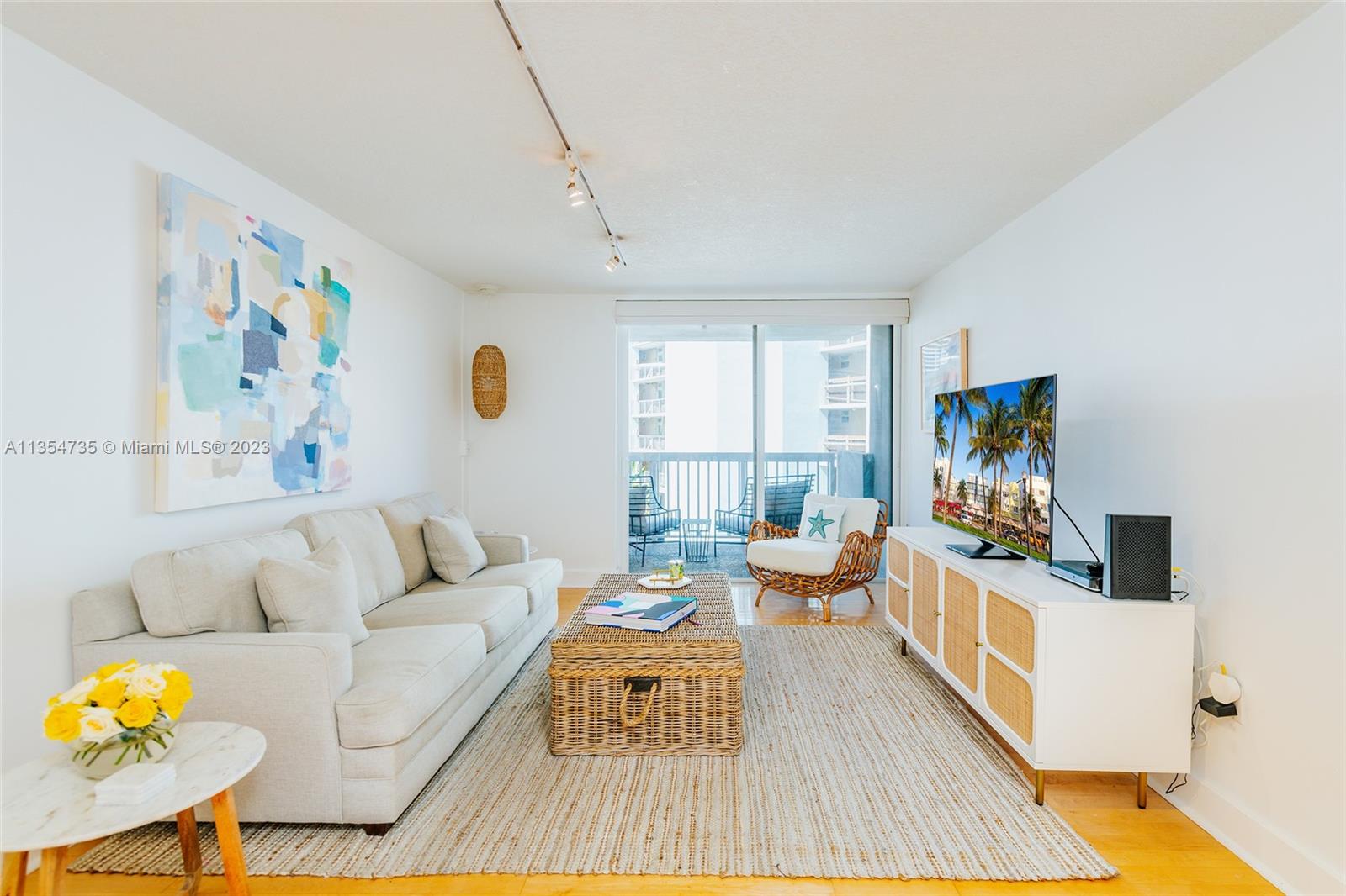1670 Bay Road, Unit 4F Miami Beach, FL 33139 - Photo 4 of 12 a living room with furniture and a flat screen tv