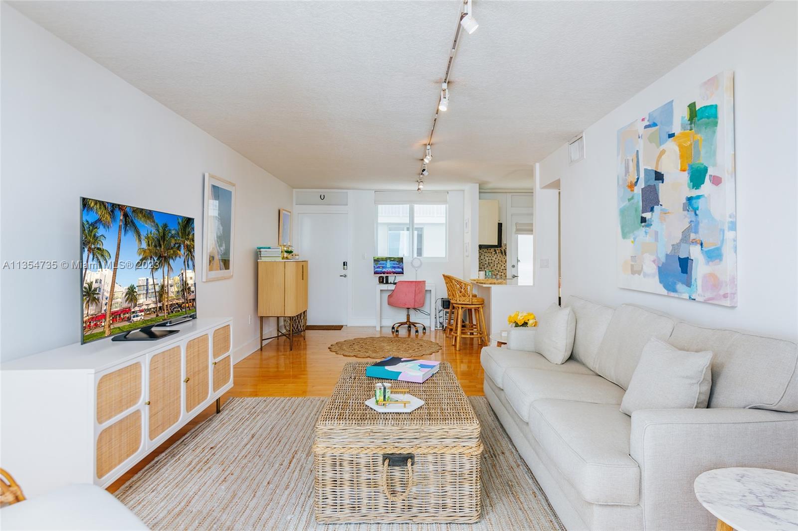 1670 Bay Road, Unit 4F Miami Beach, FL 33139 - Photo 5 of 12 a living room with furniture and a flat screen tv