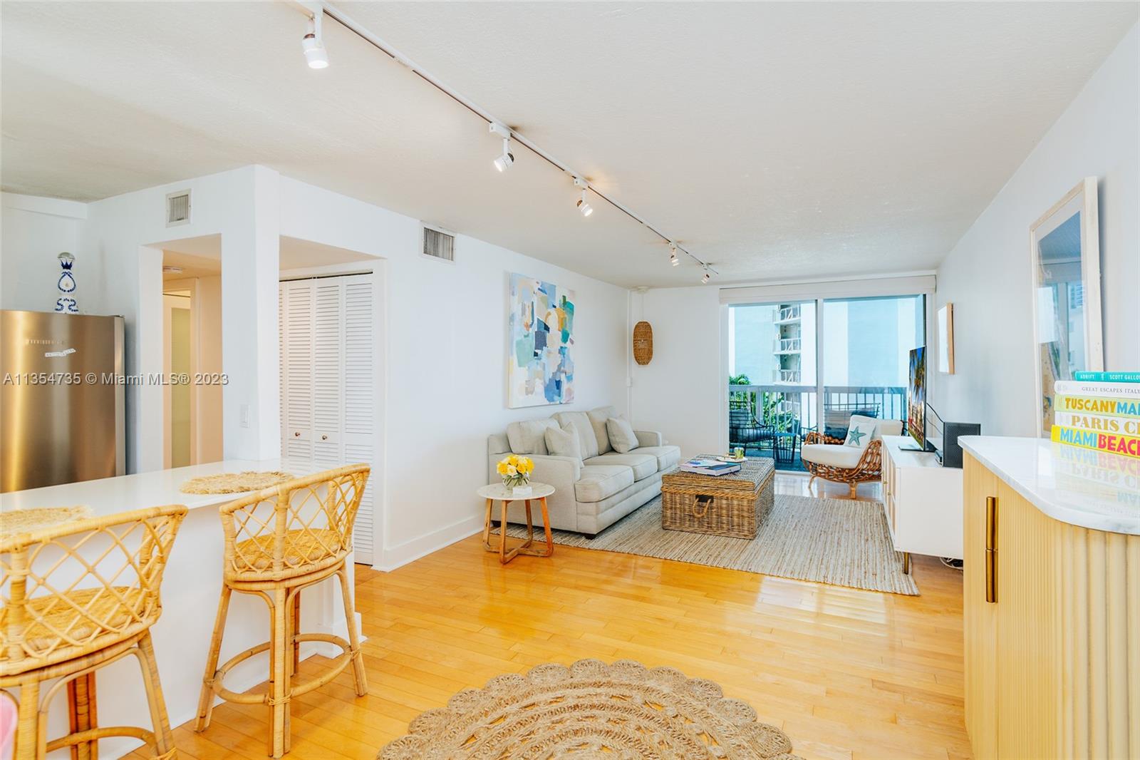 1670 Bay Road, Unit 4F Miami Beach, FL 33139 - Photo 6 of 12 a living room with furniture and a table