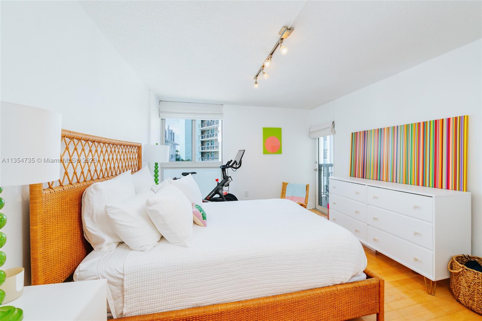 1670 Bay Road, Unit 4F Miami Beach, FL 33139 - Photo 8 of 12 a large bed sitting in a bedroom next to a window