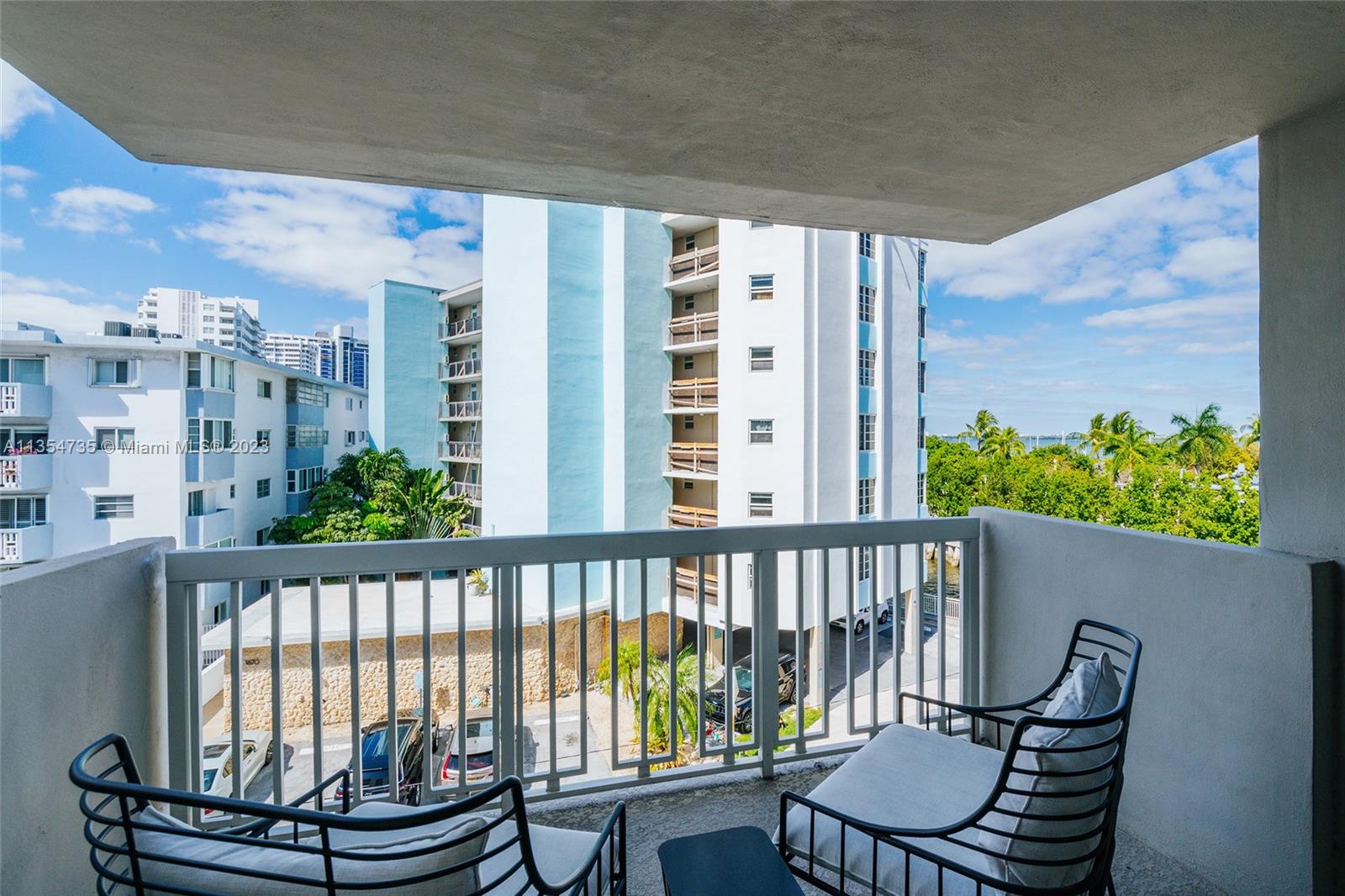 1670 Bay Road, Unit 4F Miami Beach, FL 33139 - Photo 10 of 12 a view of a balcony with chairs