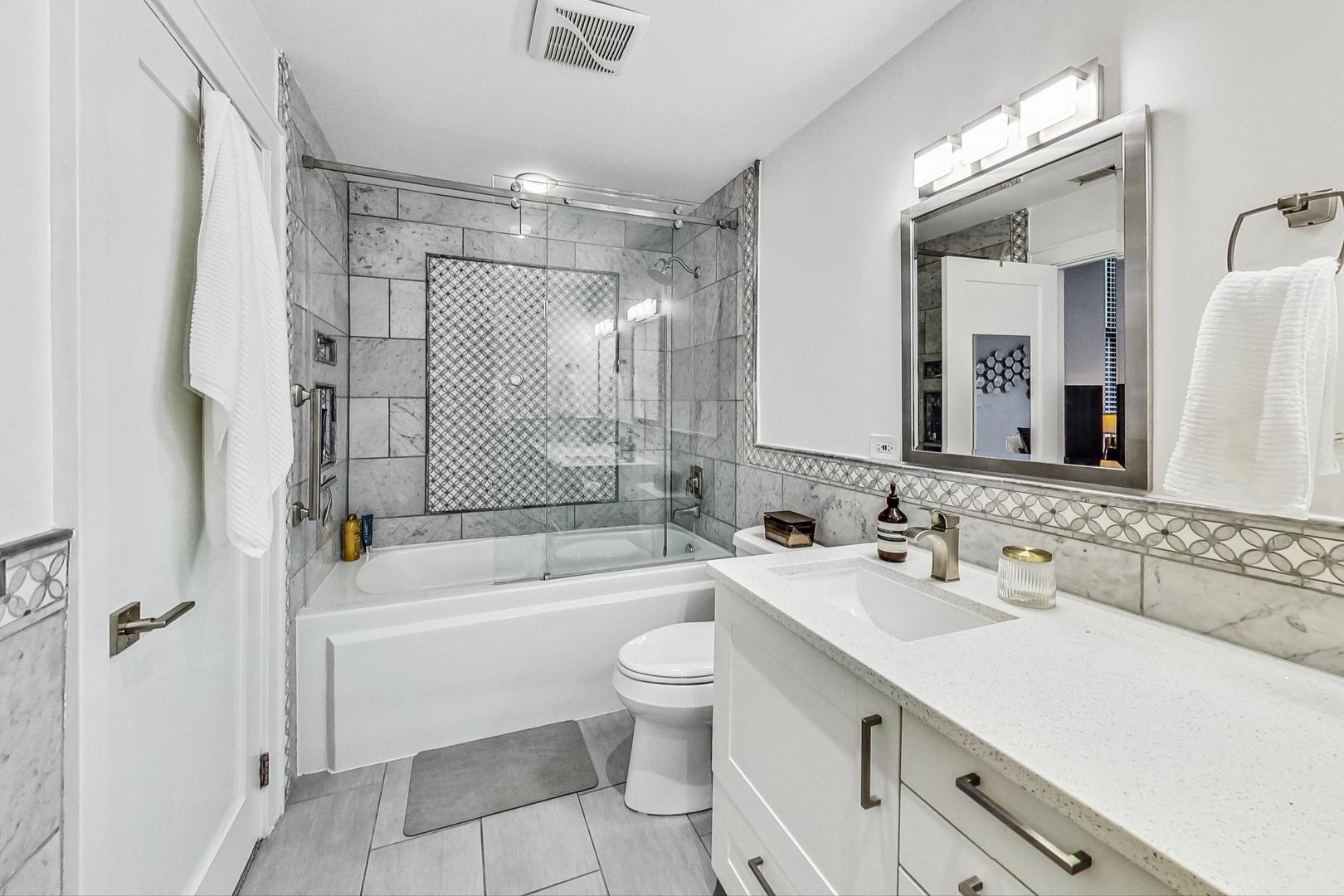 811 South Lytle Street, Unit 611 Chicago, IL 60607 - Photo 13 of 29 a bathroom with a double vanity sink toilet mirror and shower
