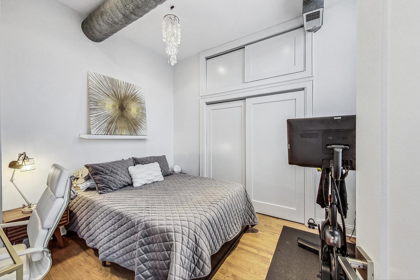 811 South Lytle Street, Unit 611 Chicago, IL 60607 - Photo 14 of 29 a bedroom with a bed and a chandelier