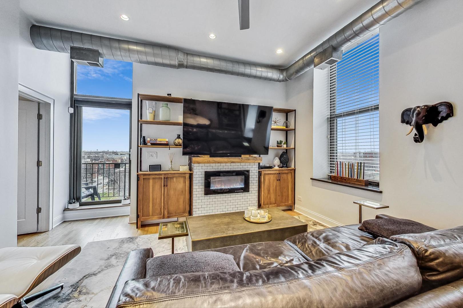 811 South Lytle Street, Unit 611 Chicago, IL 60607 - Photo 4 of 29 a bedroom with furniture and a fireplace