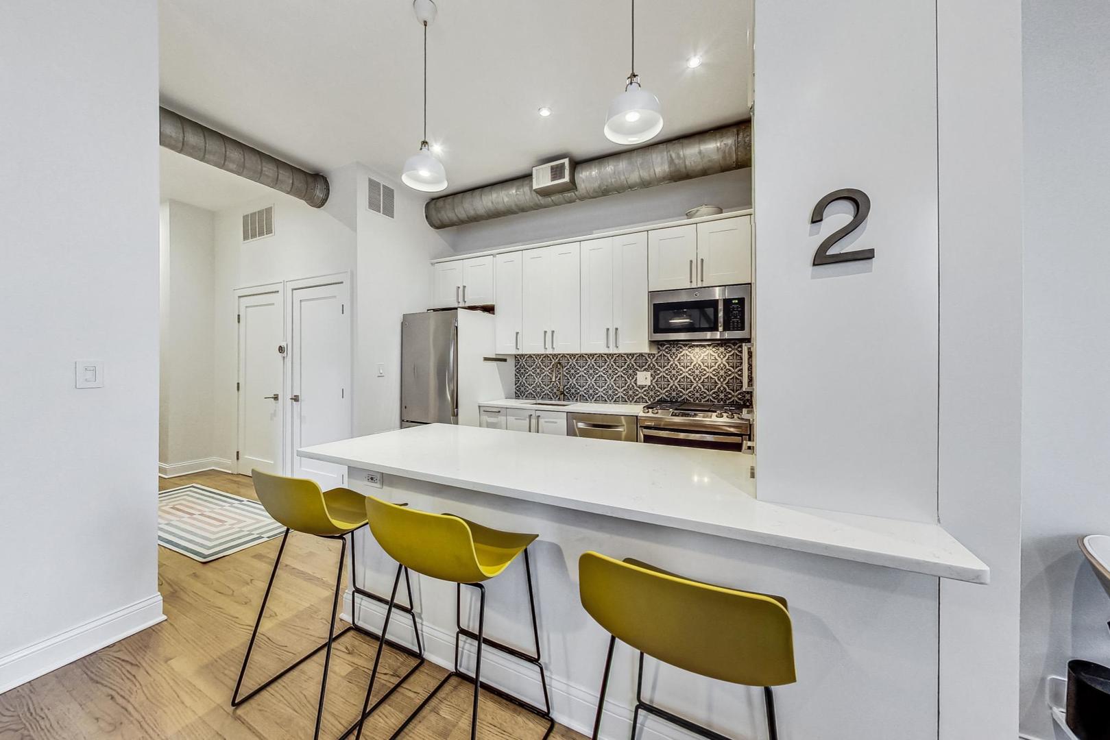 811 South Lytle Street, Unit 611 Chicago, IL 60607 - Photo 7 of 29 a kitchen with stainless steel appliances granite countertop a sink refrigerator and microwave