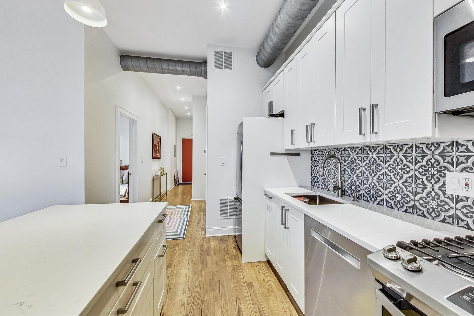 811 South Lytle Street, Unit 611 Chicago, IL 60607 - Photo 9 of 29 a kitchen with stainless steel appliances a stove a sink and a refrigerator