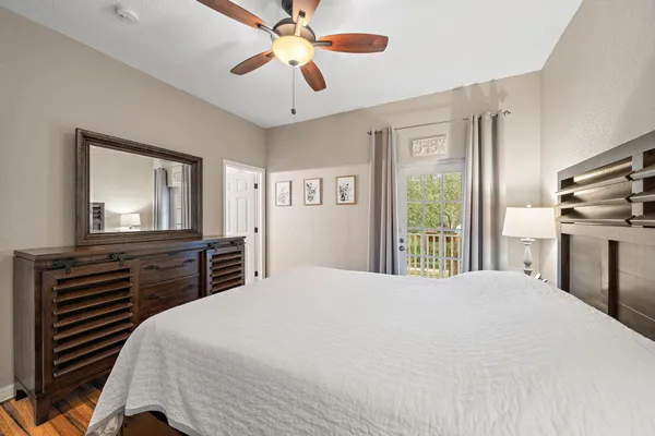 a bedroom with a large bed and flat tv screen on dresser