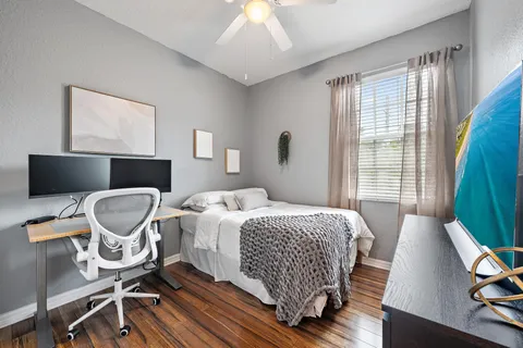 a bedroom with a bed chair and a window