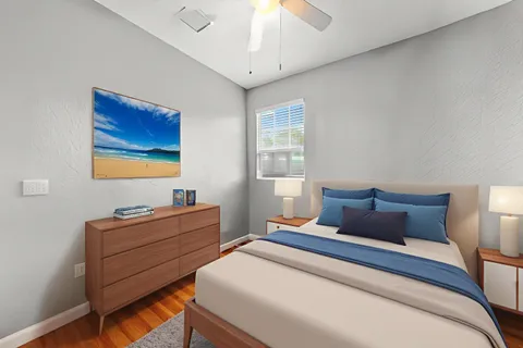 a bedroom with bed and wooden floor