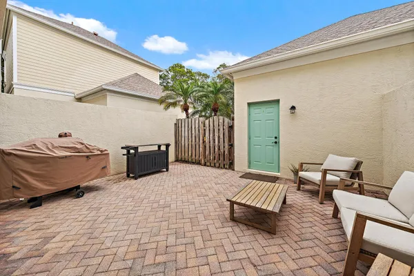 a view of a patio with table and chairs and potted plants