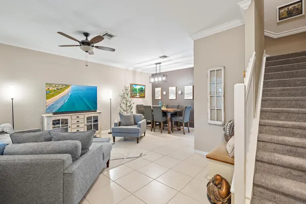 a living room with furniture and wooden floor