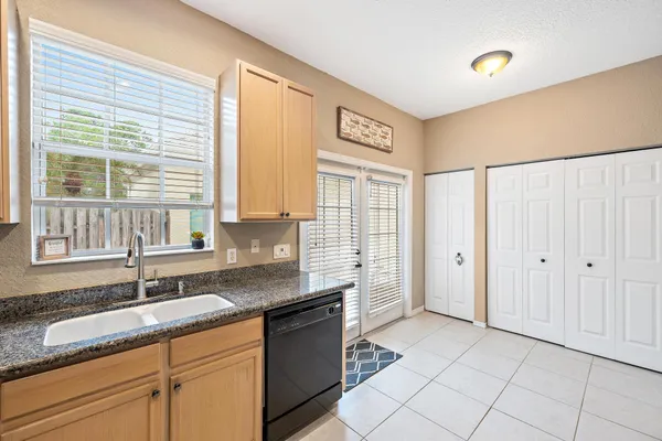 a kitchen with granite countertop a sink and a stove