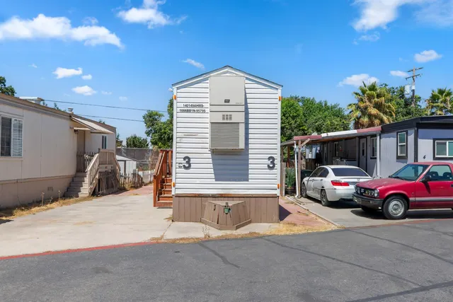 a front view of a house with parking space