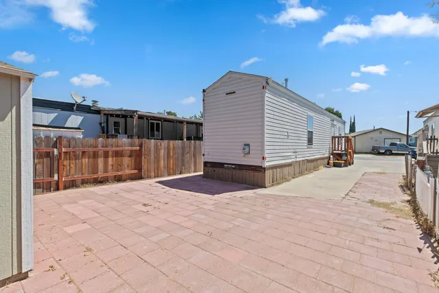 an aerial view of residential house with outdoor space and wooden deck