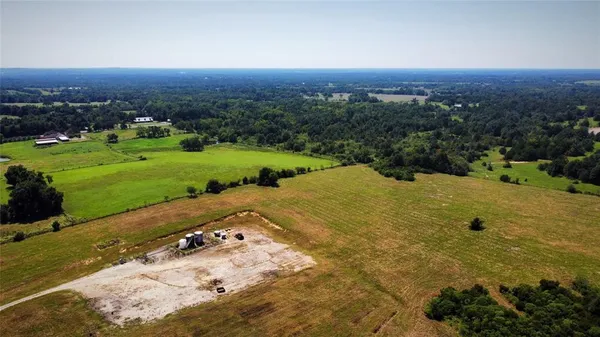 an aerial view of a house with a yard swimming pool and outdoor seating
