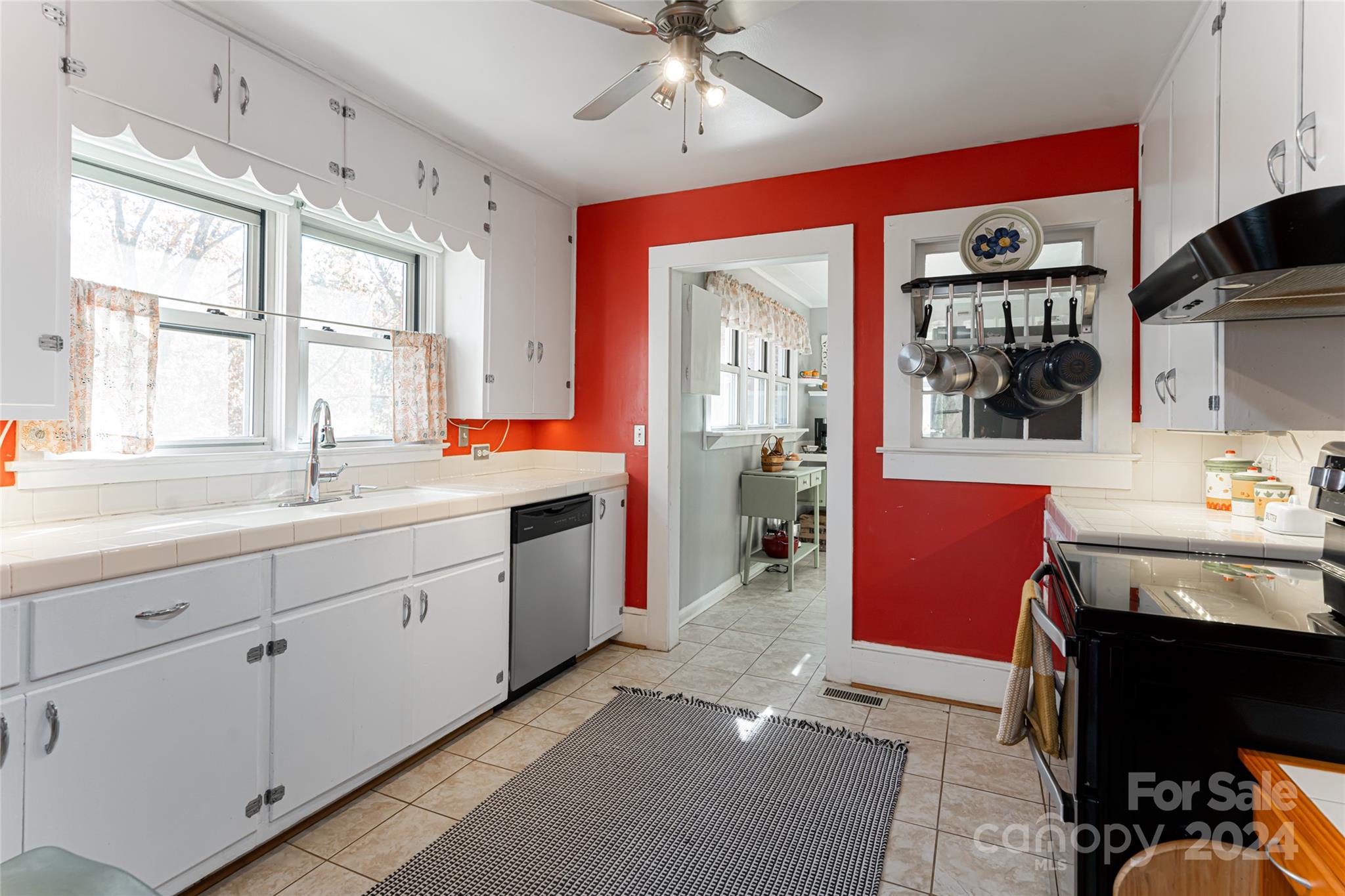 5074 Thickety Road Canton, NC 28716 - Photo 13 of 48 a spacious kitchen with stainless steel appliances granite countertop a sink and cabinets