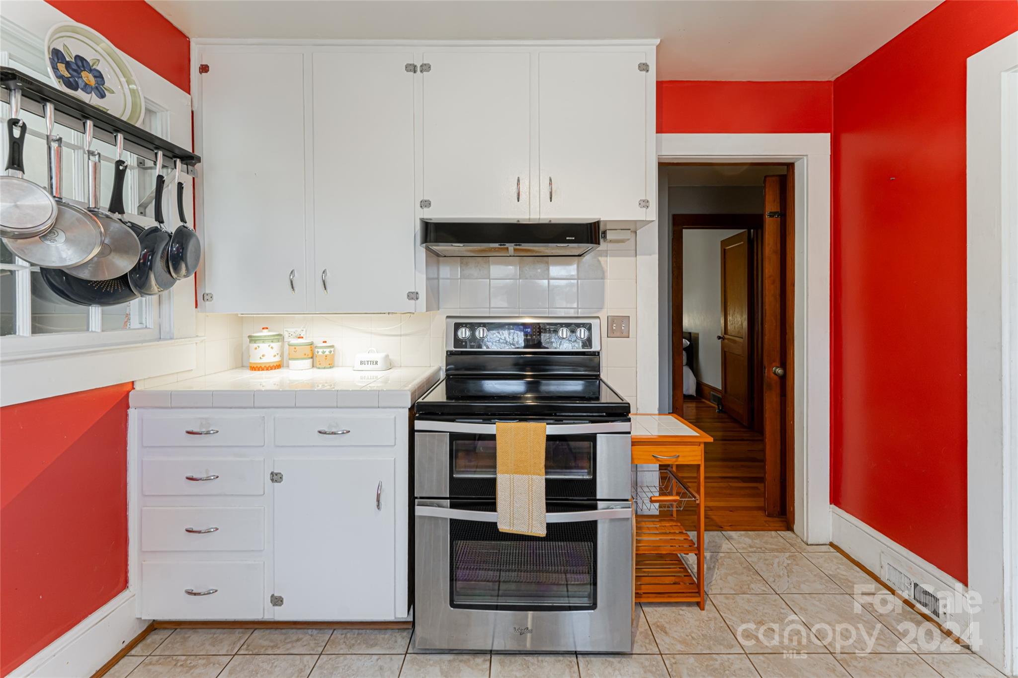 5074 Thickety Road Canton, NC 28716 - Photo 14 of 48 a kitchen with granite countertop a stove and a cabinets