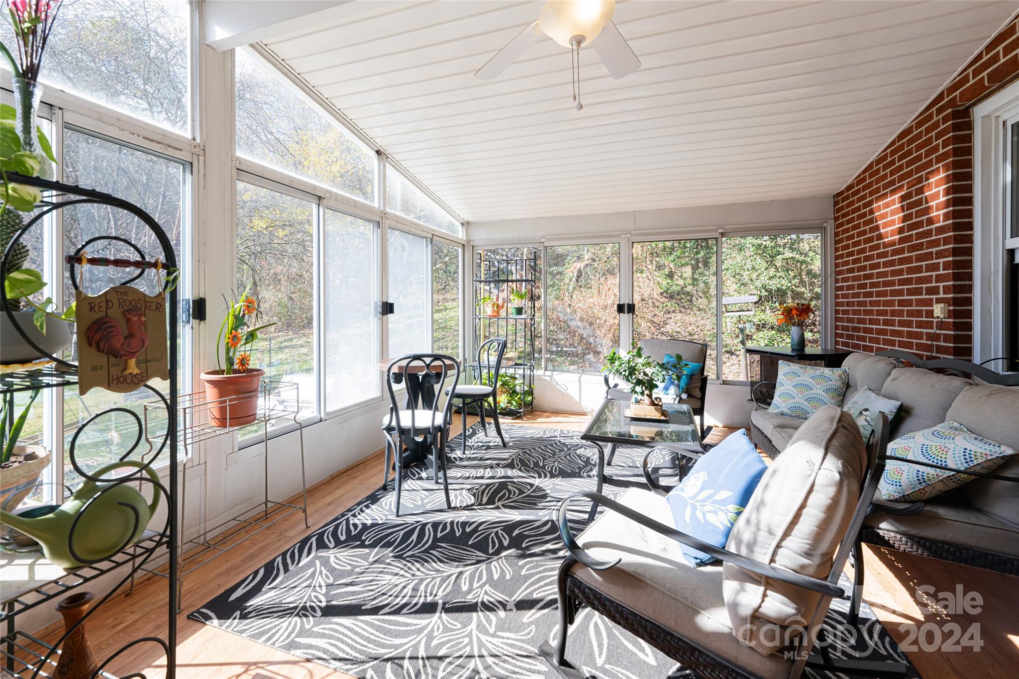 5074 Thickety Road Canton, NC 28716 - Photo 18 of 48 a living room with furniture and floor to ceiling windows