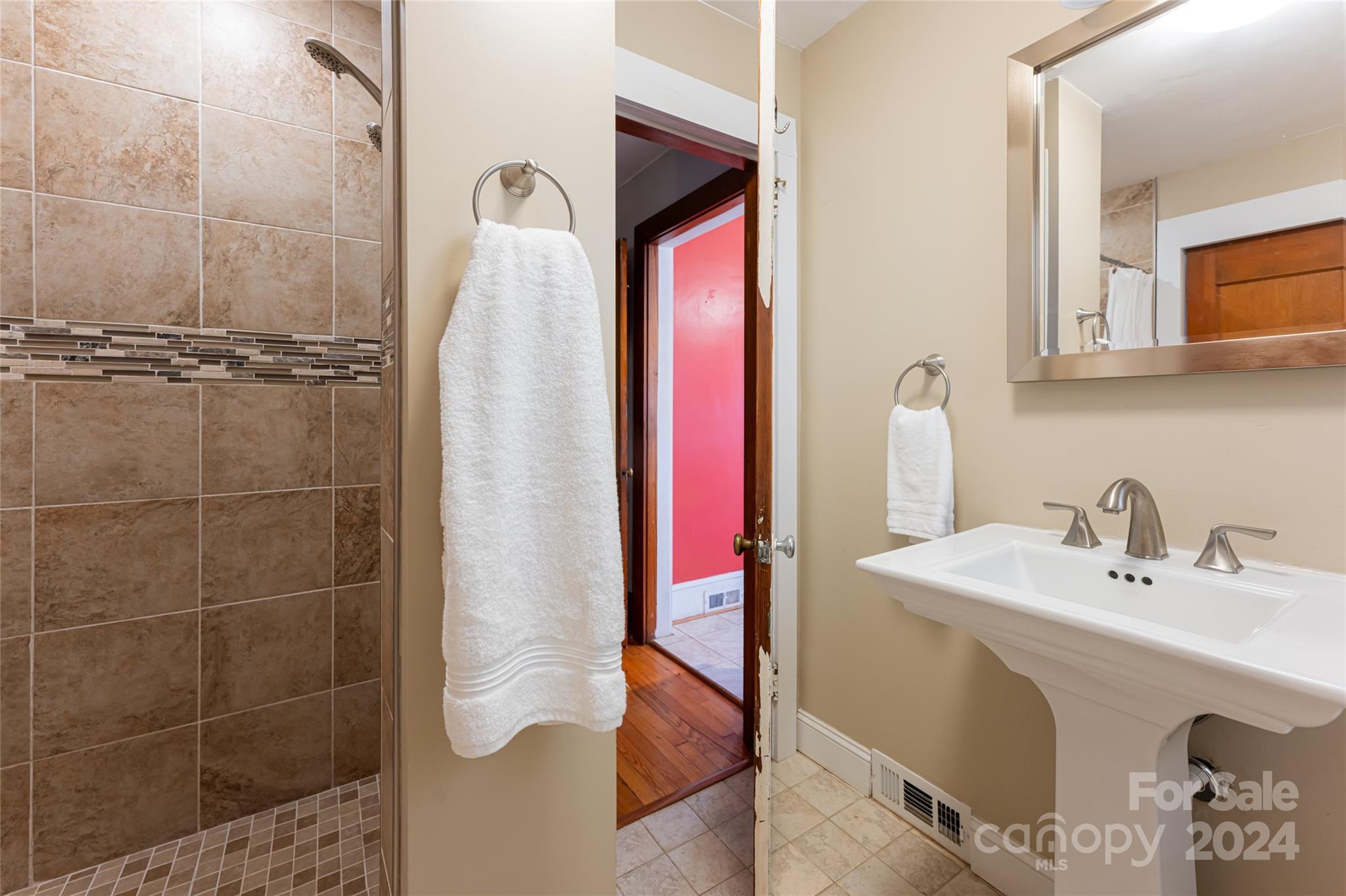 5074 Thickety Road Canton, NC 28716 - Photo 30 of 48 a bathroom with a sink vanity and a mirror