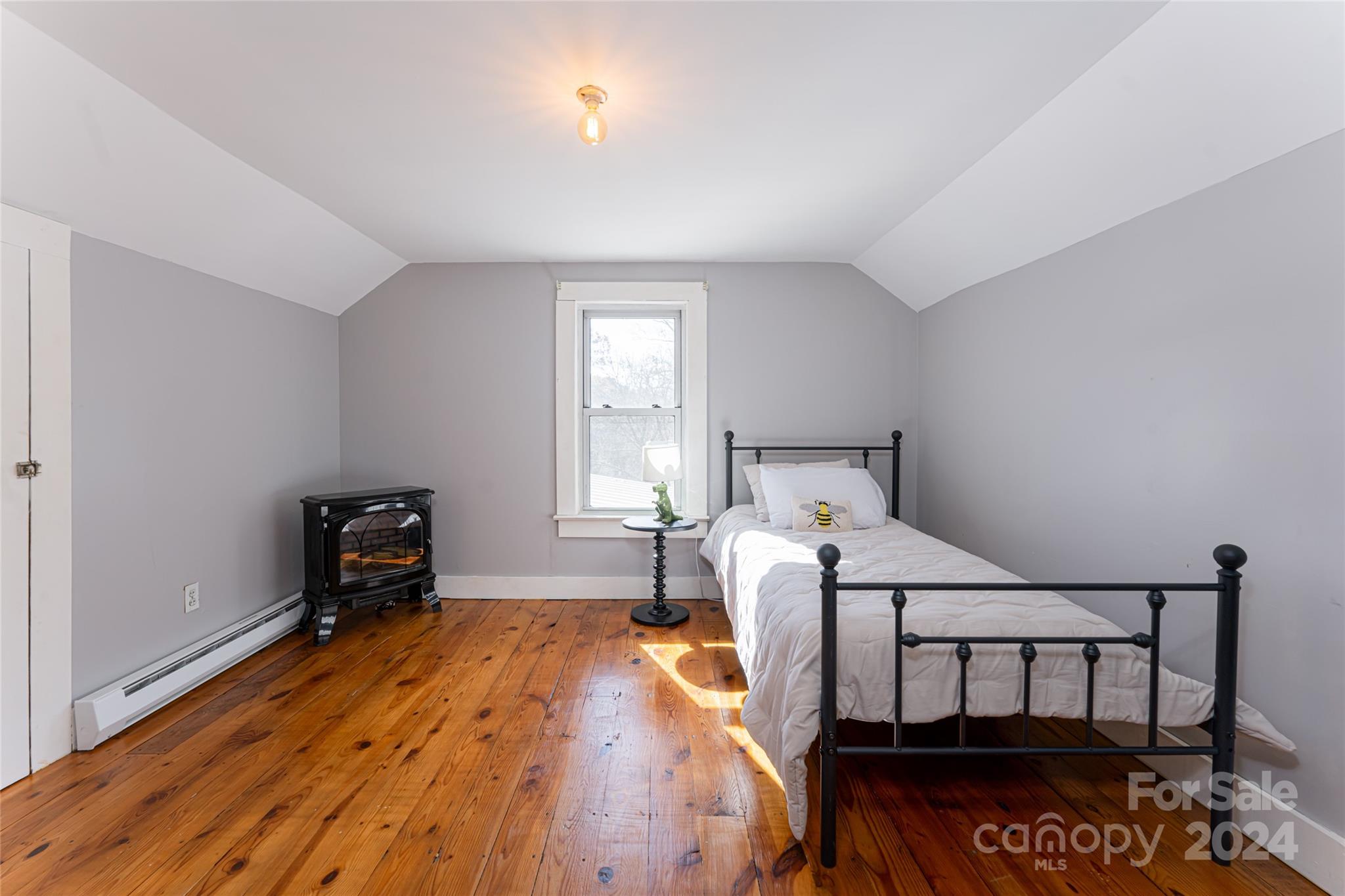 5074 Thickety Road Canton, NC 28716 - Photo 32 of 48 a bedroom with a bed and a window
