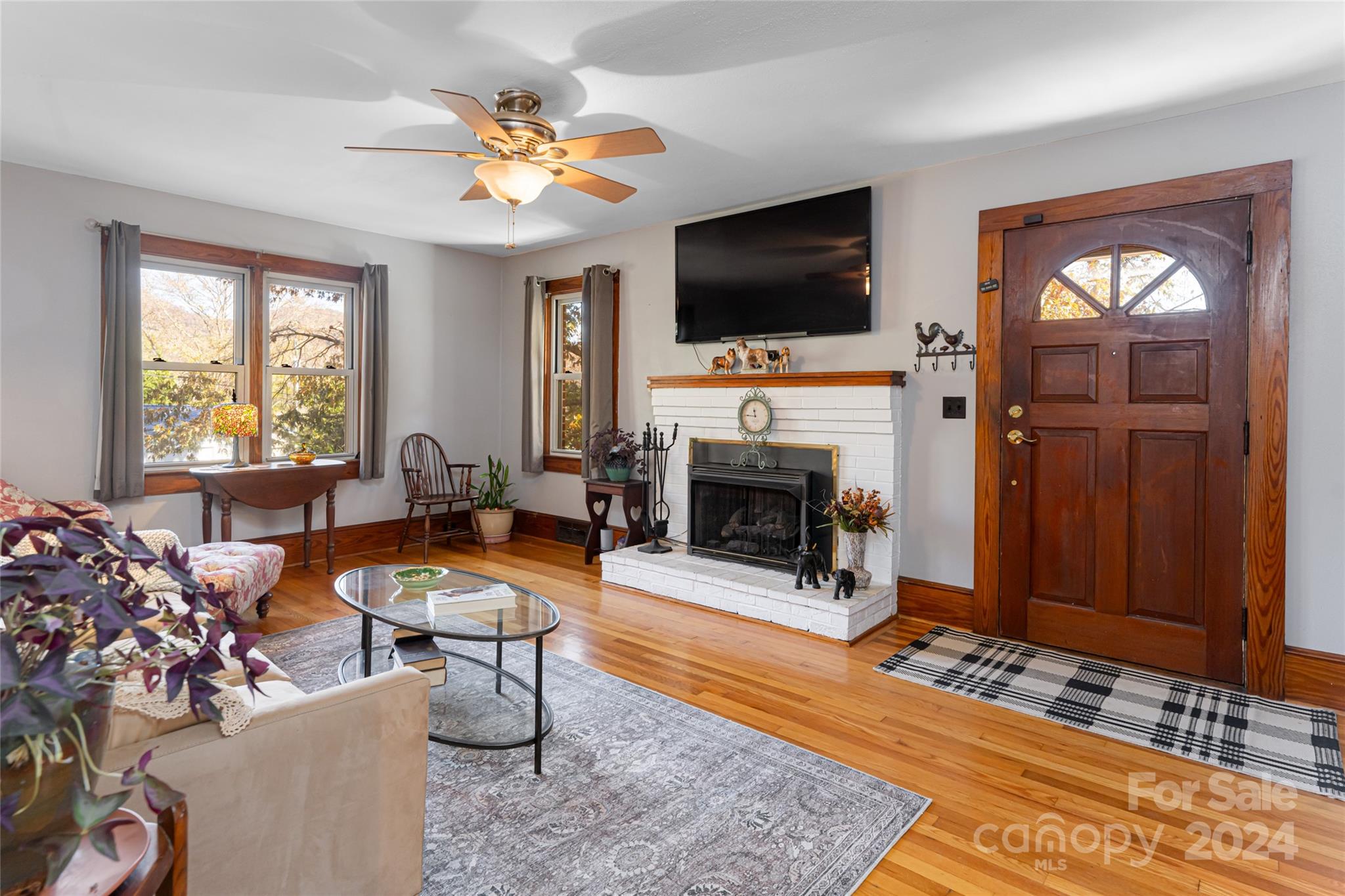 5074 Thickety Road Canton, NC 28716 - Photo 6 of 48 a living room with furniture a flat screen tv and a fireplace