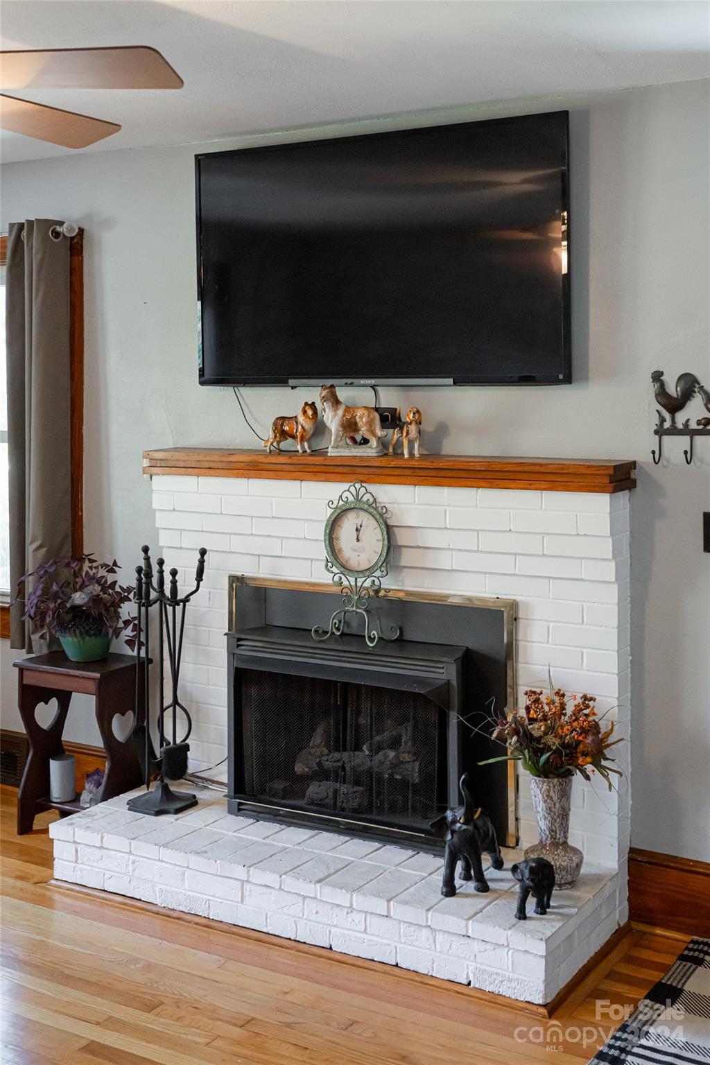 5074 Thickety Road Canton, NC 28716 - Photo 7 of 48 a living room with furniture a flat screen tv and a fireplace