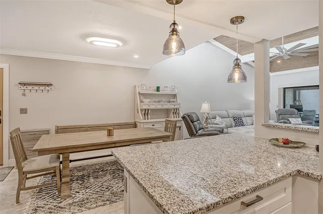 a living room with granite countertop furniture and wooden floor
