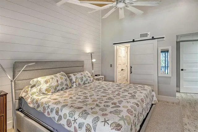 a bedroom with a bed and a chandelier