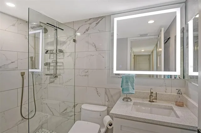 a bathroom with a sink toilet and shower