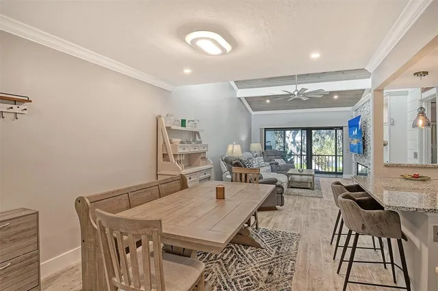 a living room with furniture a large window and a table