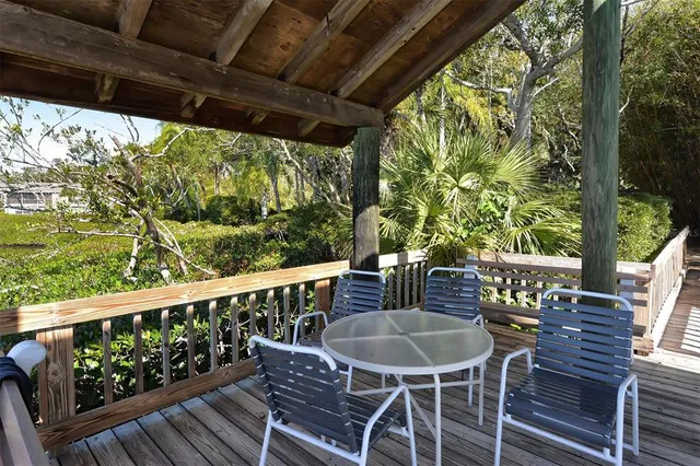 a view of a chairs and table in the balcony