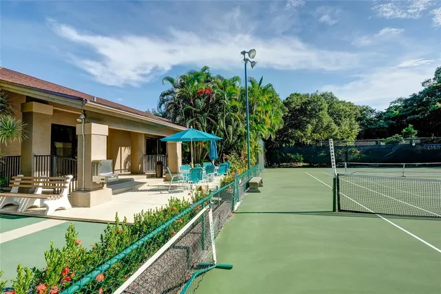a view of a house with backyard and sitting area