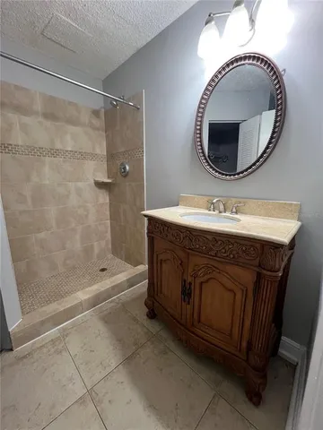 a bathroom with a sink mirror vanity and a mirror