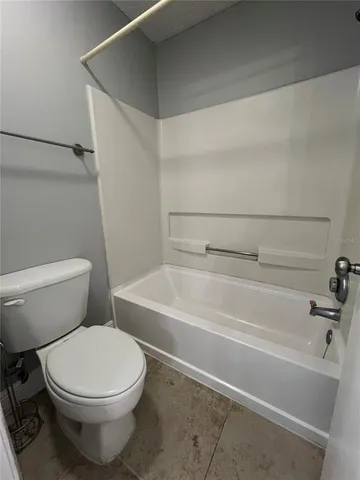 a bathroom with a toilet and a bath tub