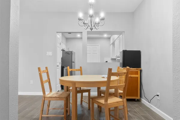 a view of a dining room with furniture and wooden floor