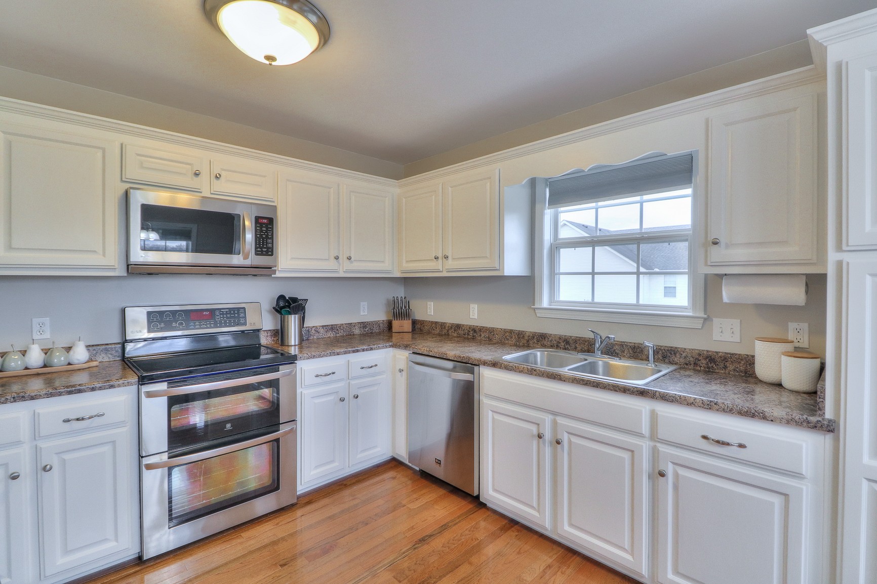 3580 Gnat Hill Road Manchester, TN 37355 - Photo 16 of 37 a kitchen with granite countertop white cabinets and white appliances