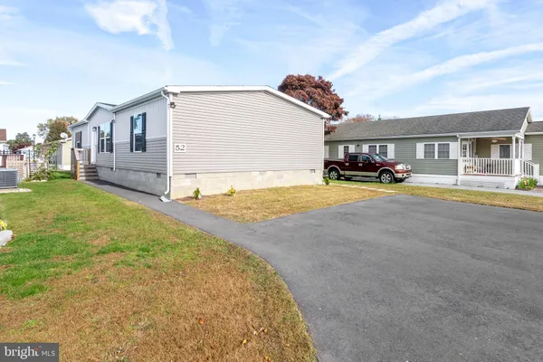 a view of a house with patio and a yard