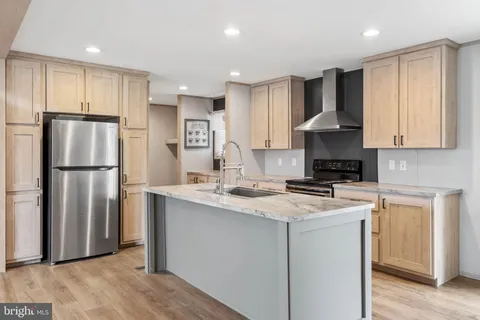 a kitchen with stainless steel appliances granite countertop a refrigerator stove a sink and a granite counter tops