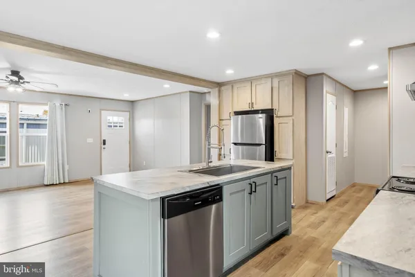 a kitchen with stainless steel appliances granite countertop a sink and refrigerator