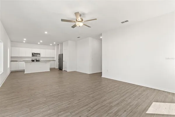 a view of a kitchen with a sink and a refrigerator