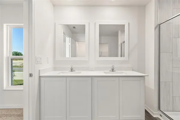 a bathroom with 2 sink and a mirror