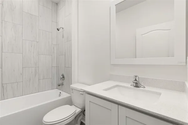 a bathroom with a sink toilet vanity and shower