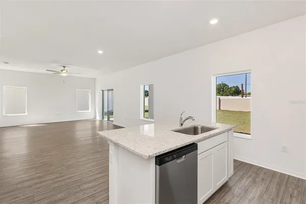 a kitchen with a sink cabinets and wooden floor