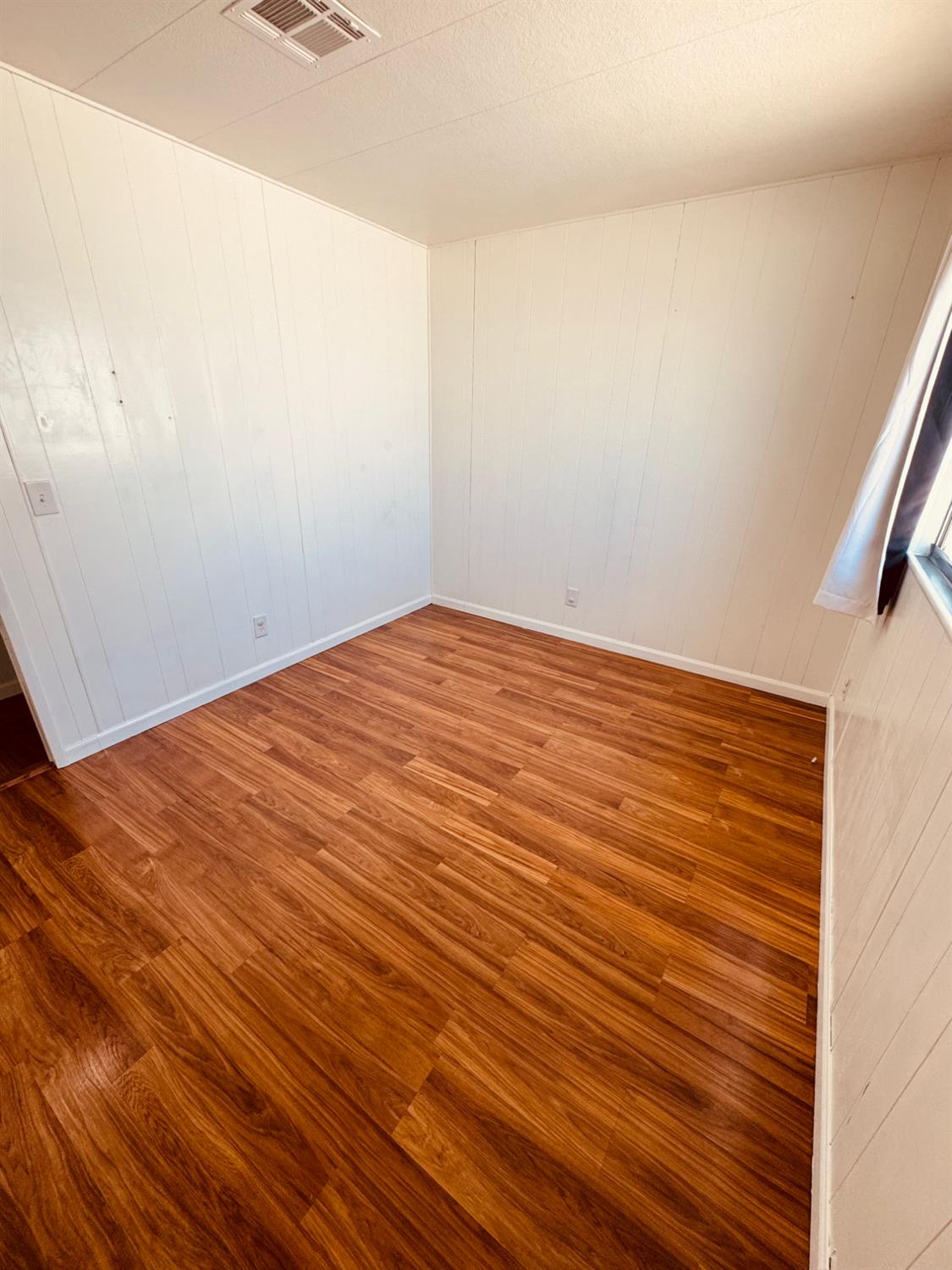 260 West Comet Road Gustine, CA 95322 - Photo 10 of 20 a view of empty room with wooden floor