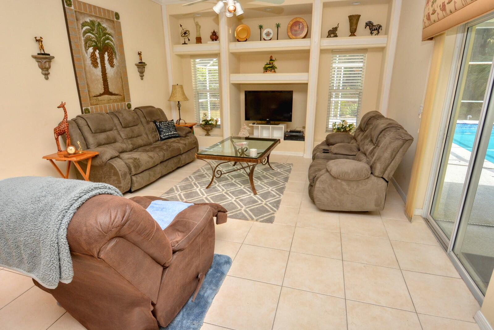 2041 Southwest Villanova Road Port St. Lucie, FL 34953 - Photo 12 of 42 a living room with furniture a rug and a fireplace
