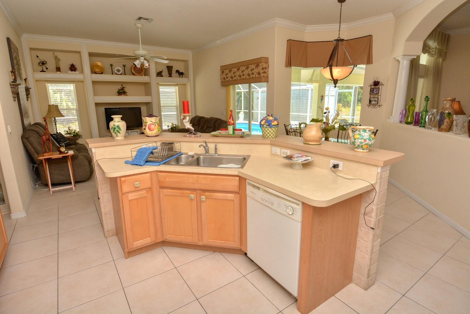 2041 Southwest Villanova Road Port St. Lucie, FL 34953 - Photo 15 of 42 a kitchen with stainless steel appliances a sink stove and cabinets